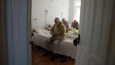 Patients with coronavirus sit in the city hospital in Rivne, Ukraine, on Octobr 22, 2021. (AP)