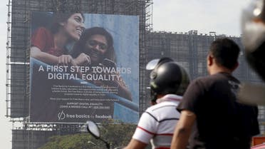 Motorists ride past a billboard displaying Facebook's Free Basics initiative in Mumbai, India. (File photo: Reuters)