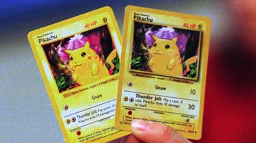 A phony Pokemon card, left, is held up next to a real one Tuesday, Dec. 14, 1999 at Nintendo's Redmond, Wash., offices. Counterfeit products have become a big enough problem that Nintendo, which owns the marketing license for all Pokemon goods, has trained customs officials and police officers in New York City and Honolulu in how to tell the difference between real and fake Pokemon cards. The real card is thicker and more of a purple tone. The lettering in the real card is darker. (AP Photo/Barry Sweet)