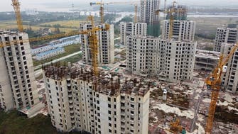 China’s debt-ridden Evergrande averts default, resumes work on more than 10 projects 