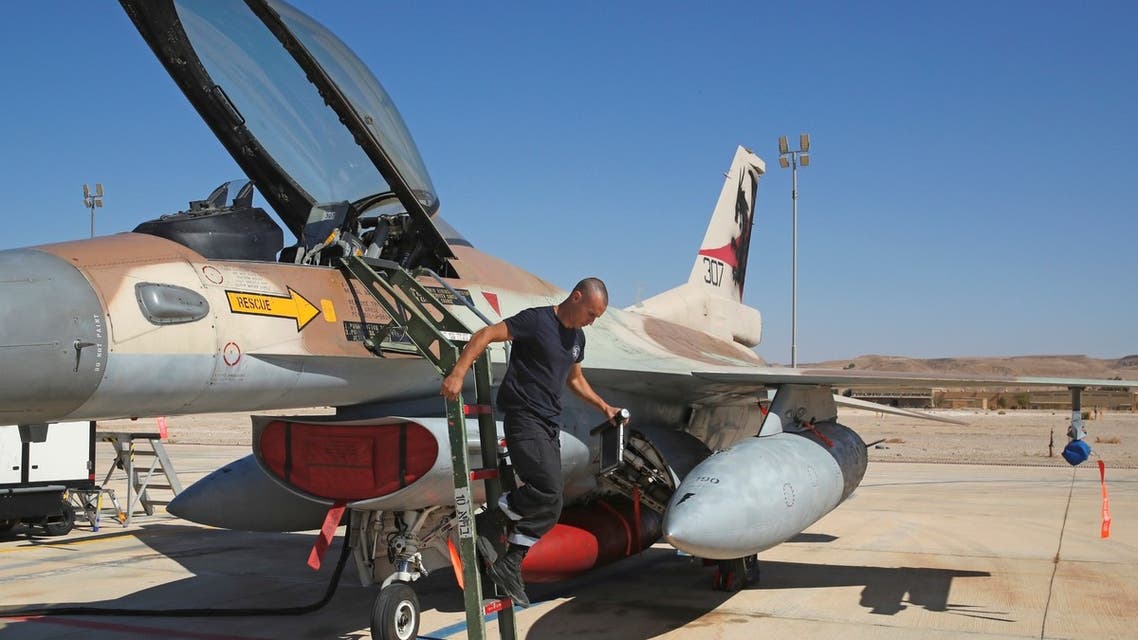 An Israeli air force mechanic inspects an F-16 fighter during the Blue Flag multinational air defence exercise at the Ovda air force base, north of the Israeli city of Eilat, on October 24, 2021. (AFP)