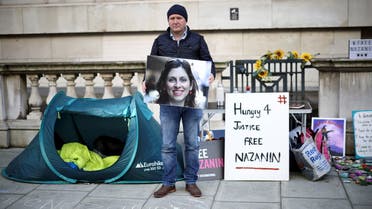 Richard Ratcliffe, husband of British-Iranian aid worker Nazanin Zaghari-Ratcliffe, holds an image of his wife during a second hunger strike, outside the Foreign, Commonwealth and Development Office (FCDO) in London, Britain October 25, 2021. (Reuters)