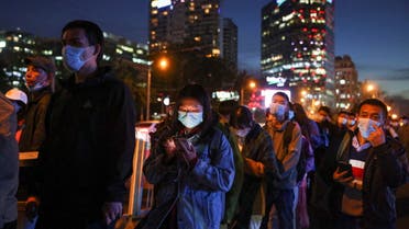 People line up at a bus stop during evening rush hour in Beijing as outbreaks of coronavirus disease (COVID-19) continue, in China, October 19, 2021. (Reuters)