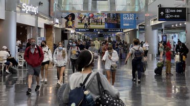In this file photo taken on August 01, 2021 passengers and others walk at Miami International Airport (MIA)in Miami, Florida. (AFP)