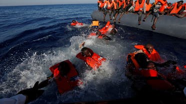 Migrants try to stay afloat after falling off their rubber dinghy during a rescue operation by the Malta-based NGO Migrant Offshore Aid Station (MOAS) ship in the central Mediterranean in international waters some 15 nautical miles off the coast of Zawiya in Libya, April 14, 2017. All 134 sub-Saharan migrants survived and were rescued by MOAS. REUTERS/Darrin Zammit Lupi