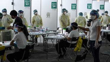 Health personnel prepare antigen rapid test for Covid-19 coronavirus for passengers at Marina Bay Cruise Centre in Singapore on November 6, 2020. (AFP)