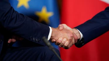 US President Joe Biden, left, and French President Emmanuel Macron shake hands during a meeting, Oct. 29, 2021. (AP)