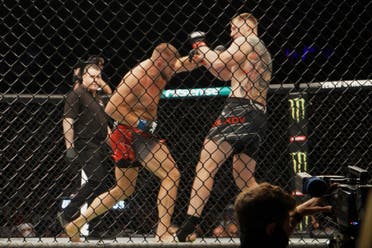 Marcin Tybura strikes Alexander Volkov in their heavyweight bout at UFC 267 in Abu Dhabi. (Al Arabiya English)
