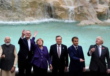 G20 leaders from left, India's Prime Minister Narendra Modi, Australia's Prime Minister Scott Morrison, German Chancellor Angela Merkel, Italy's Prime Minister Mario Draghi, French President Emmanuel Macron and British Prime Minister Boris Johnson perform the traditional coin toss in front of the Trevi Fountain during an event for the G20 summit in Rome, Sunday, Oct. 31, 2021. (AP)