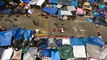 Aerial view of an improvised migrants and asylum seekers camp outside El Chaparral crossing port as they wait for US authorities to allow them to start their migration process in Tijuana, Baja California state, Mexico on May 9, 2021. / AFP / Guillermo Arias