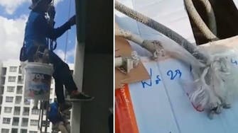Woman cuts ropes of painters at Thailand high rise building, leaves them hanging