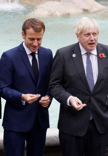 Britain's Prime Minister Boris Johnson gestures next to Australia's Prime Minister Scott Morrison in front of the Trevi Fountain during the G20 summit in Rome, Italy, October 31, 2021. REUTERS/Guglielmo Mangiapane