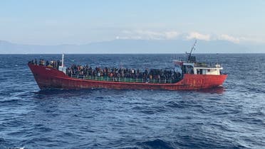 A cargo ship carries migrants during a rescue operation, as it sails off the island of Crete, Greece, October 29, 2021. (Reuters)