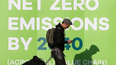 A man walks past a advertising in relation with the UN Climate Change Conference (COP 26) where world leaders discuss how to tackle climate change on a global scale, near the conference area in Glasgow Scotland, Britain October 30, 2021. (Reuters)