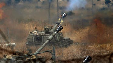 Israeli self-propelled howitzers fire towards Lebanon from a position near the northern Israeli town of Kiryat Shmona following rocket fire from the Lebanese side of the border, on August 6, 2021. (AFP)