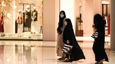 Women wearing masks for protection against the coronavirus, walk in the Dubai Mall on April 28, 2020. (AFP)