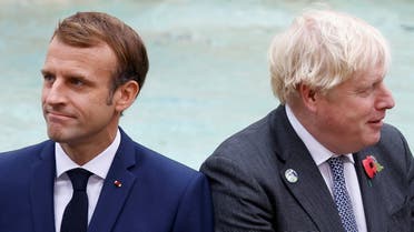 Britain's Prime Minister Boris Johnson and French President Emmanuel Macron look on in front of the Trevi Fountain during the G20 summit in Rome, Italy, October 31, 2021. (Reuters)