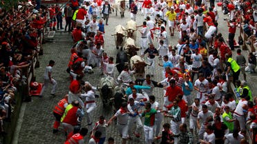  Runners sprint in front of Torrestrella fighting bulls at the entrance to the bullring during the first running of the bulls of the San Fermin festival in Pamplona July 7, 2014. (File Photo: Reuters)