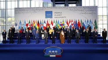 Italian Prime Minister Mario Draghi (C-front) stands with world leaders as they gather for the official family photograph on day one of the G20 Summit at the convention center of La Nuvola, in the EUR district of Rome on October 30, 2021. (AFP)