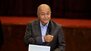 Iraq's President Barham Salih casts his vote at a polling station in Baghdad, as Iraqis go to the polls to vote in the parliamentary election, in Iraq, October 10, 2021. REUTERS/Thaier al-Sudani