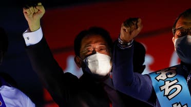 Japan’s Prime Minister Fumio Kishida, who is also the President of the ruling Liberal Democratic Party, raises his fist with the party’s candidates atop the campaigning bus on the last day of campaigning for the October 31 lower house election, amid the coronavirus, in Tokyo, Japan, on October 30, 2021. (Reuters)