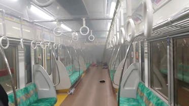 Smoke is seen in a carriage of a Tokyo train line following a knife, arson and acid attack, in Tokyo, Japan October 31, 2021 in this still image obtained from a social media video. (Reuters)