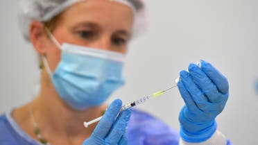 FILE PHOTO: A nurse draws a dose of the BioNtech vaccine against coronavirus disease (COVID-19) at a vaccination centre at the Dresden Fair, in Dresden, Germany, July 29, 2021. REUTERS/Matthias Rietschel/File Photo