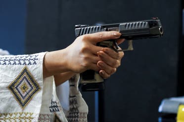 Saudi female firearm trainer Mona Al Khurais takes aim with her pistol at the Top-Gun shooting range in Riyadh, Saudi Arabia, October 28, 2021. Picture taken October 28, 2021. (Reuters)