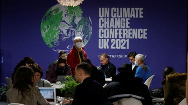 Delegates wear protective face masks as they gather in a communal area during the UN Climate Change Conference (COP26) in Glasgow, Scotland, Britain, October 31, 2021. REUTERS/Phil Noble