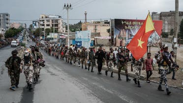TOPSHOT - Tigray People's Liberation Front (TPLF) fighters walk in lines towards another field in Mekele, the capital of Tigray region, Ethiopia, on June 30, 2021. Rebel fighters in Ethiopia's war-hit Tigray seized control of more territory on June 29, 2021, one day after retaking the local capital and vowing to drive all enemies out of the region. (Photo by Yasuyoshi Chiba / AFP)