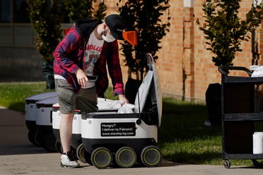  Food is loaded into a robot at the Bowling Green State University campus in Bowling Green, Ohio on Thursday, Oct. 13, 2021. (AP)