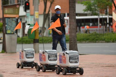 A caravan of delivery robots travel down a street in Medellin, Colombia, Tuesday, April 21, 2020. (AP)