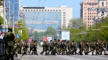 Russia-backed rebel soldiers cross a street during a rehearsal for the Victory Day military parade in Donetsk, Ukraine. (AP)