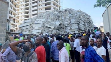People gather at the site of a collapsed 21-story building in Ikoyi, Lagos, Nigeria, November 1, 2021. (Reuters)