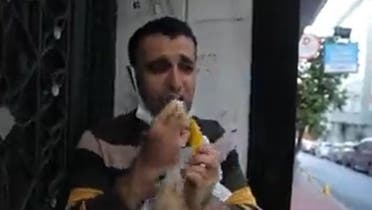 A screengrab from a video shows Majed Shamaa buys bananas in a secretive manner and hides away to eat them without being seen. (Twitter)