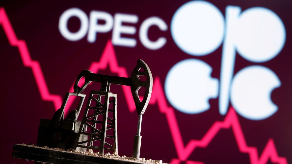 A 3D printed oil pump jack is seen in front of displayed stock graph and Opec logo in this illustration picture, April 14, 2020. (Reuters)