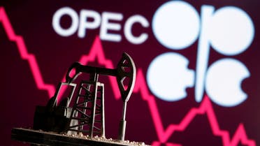 A 3D printed oil pump jack is seen in front of displayed stock graph and Opec logo in this illustration picture, April 14, 2020. (Reuters)