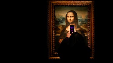 Visitors look at a copy of the Leonardo da Vinci's Mona Lisa, which will go up for auction on November 9, at the Artcurial auction house in Paris, France, November 5, 2021. REUTERS/Noemie Olive