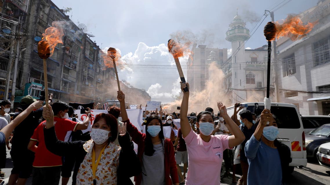 FILE PHOTO: A group of women hold torches as they protest against the military coup in Yangon, Myanmar July 14, 2021. REUTERS/Stringer/File Photo