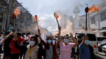FILE PHOTO: A group of women hold torches as they protest against the military coup in Yangon, Myanmar July 14, 2021. REUTERS/Stringer/File Photo