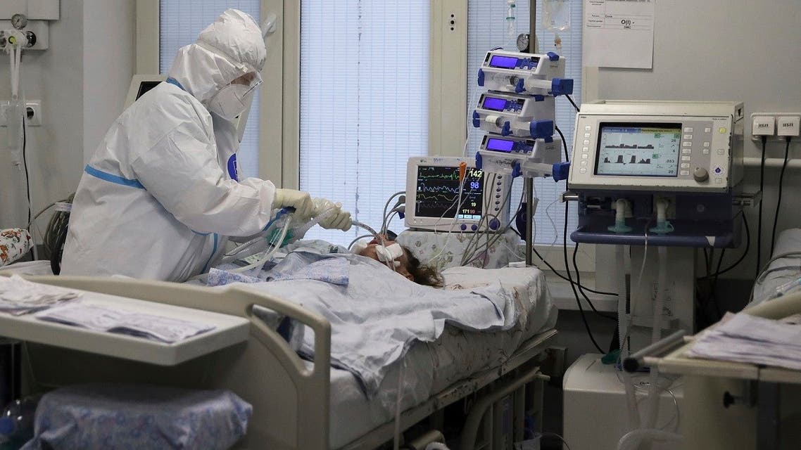 A medical staffer wearing a special suit to protect against COVID-19 treats a patient with coronavirus at an ICU at the Regional Clinical Hospital 1, in Krasnodar, south Russia, on Nov. 2, 2021. (AP)