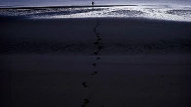 Man hunts for fish using a spear as he walks along the beach on Cotton Island, located inside Arnhem Land in the Northern Territory July 17, 2013. (File photo: Reuters)
