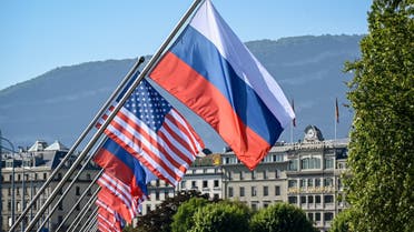 Russians and US flags are seen on the Mont-Blanc bridge on June 16, 2021 in Geneva ahead of the summit between Russian leader and US President. (AFP)