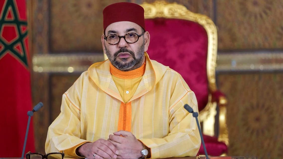 A picture released by the Moroccan Royal Palace shows Morocco's King Mohammed VI addressing speech, transmitted via a screen to the parliament, from the Royal Palace in the northeastern city of Fez, on October 8, 2021. (AFP)