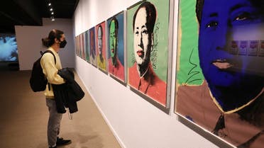 Kourosh Aminzadeh, a student of graphics, looks at China's late leader, Mao Zedong painting series by American artist Andy Warhol at Tehran Museum of Contemporary Art in Tehran, Iran, on Oct. 19, 2021. (AP)
