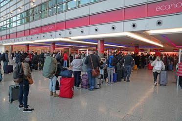 Passengers queue at London Heathrow Airport's T3 as the US reopens its borders to UK visitors in a significant boost to the travel sector, in London, on Nov. 8, 2021. (AP)