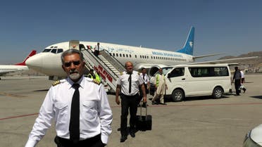 Pilots of Ariana Afghan Airlines walk on the tarmac after landing at Hamid Karzai International Airport in Kabul, Afghanistan, Sunday, Sept. 5, 2021. (File photo: AP)