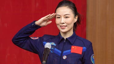 (FILES) In this file photo taken on October 14, 2021, Chinese astronaut Wang Yaping, member of the second crew for China's new space station, salutes during a briefing the day before the launch at the Jiuquan Satellite Launch Centre in the Gobi desert, in northwest China. Wang became the first Chinese woman to walk in space, authorities said on November 8, 2021, as her team completed a six-hour stint outside the Tiangong space station as part of its ongoing construction. (Photo by AFP) / NO USE AFTER DECEMBER 8, 2021 03:49:10 GMT - CHINA OUT