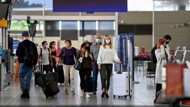 Passengers wear face masks as they arrive at the departures terminal at Sydney Domestic Airport in Sydney, Australia, on Nov. 5, 2021. (AP)