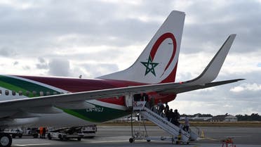People board a Royal Air Maroc flight on July 15, 2020 at Bordeaux's airport. Moroccans and foreign residents in Morocco, as well as their families, have been allowed from July 14, 2020 midnight to return to the kingdom only by plane or by boat. (AFP)
